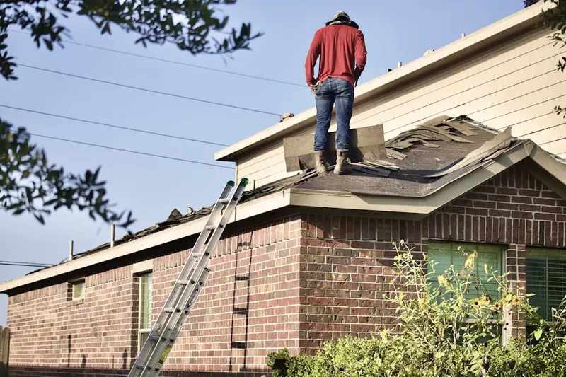 Professional roofer working on a residential roof in Hillcrest Manor